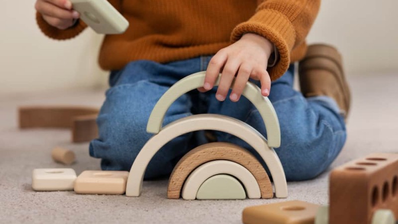 front-view-boy-playing-with-eco-toys-indoors