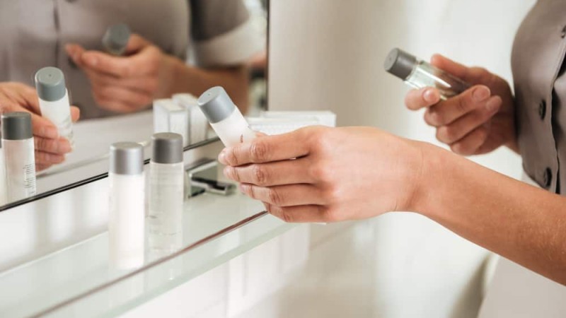 young-hotel-maid-putting-bath-accessories-bathroom